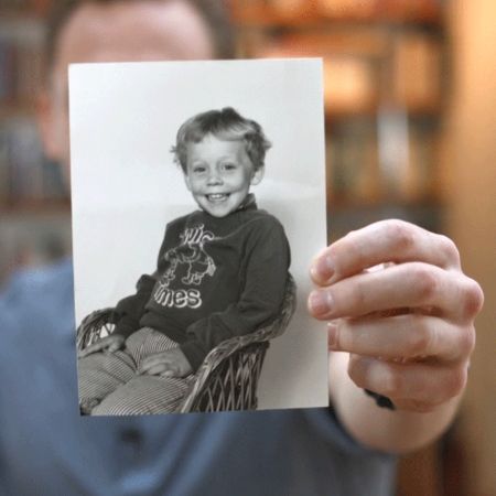 Tom Hiddleston holding a picture of when he was young